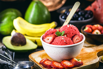 vegan strawberry ice cream with tropical fruits in the background, strawberry, banana, avocado and jabuticaba