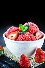 red strawberry ice cream, homemade and organic with no added milk, made with frozen strawberries
