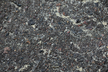 background texture rough asphalt with stones and sand close-up soft focute