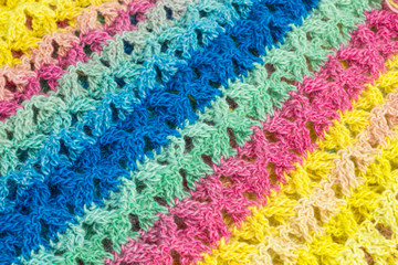 handmade multicolor crochet background in yellow, green and pink with double crochet stitches