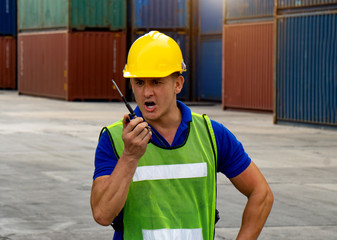 industrial worker is controlling container loading in import-export business.