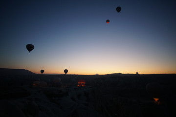 Hot air balloon flying over rock landscape at Cappadocia Turkey