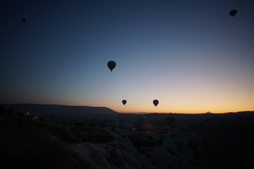 Hot air balloon flying over rock landscape at Cappadocia Turkey