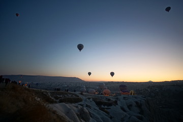 Hot air balloon flying over rock landscape at Cappadocia Turkey