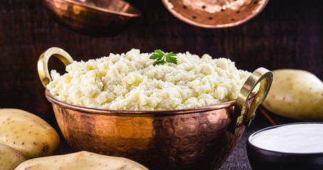 mashed potatoes in copper metallic pan, Brazilian food served as a garnish or side dish.
