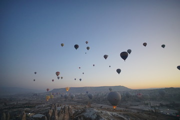 Hot air balloon flying over rock landscape at Cappadocia Turkey