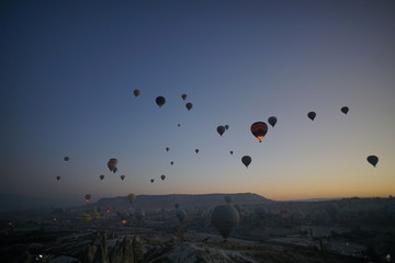 Hot air balloon flying over rock landscape at Cappadocia Turkey