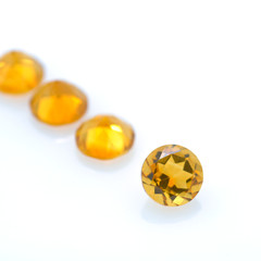 Lot of citrine quartz stones with diamond cut. Nice yellow-orange gemstone on isolated background.