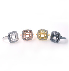 Set of colored rings with inlaid precious stones. Chromed metal rings on a neutral background.