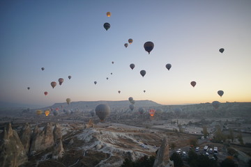 Hot air balloon flying over rock landscape at Cappadocia Turkey