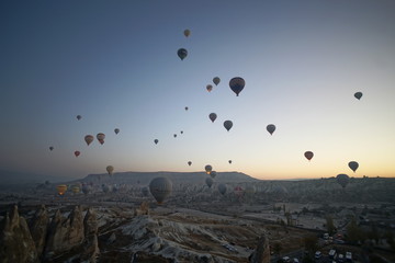 Hot air balloon flying over rock landscape at Cappadocia Turkey
