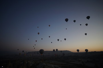 Hot air balloon flying over rock landscape at Cappadocia Turkey