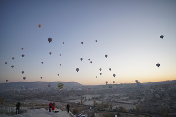 Hot air balloon flying over rock landscape at Cappadocia Turkey