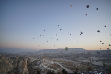 Hot air balloon flying over rock landscape at Cappadocia Turkey