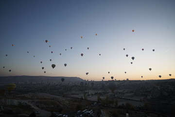 Hot air balloon flying over rock landscape at Cappadocia Turkey
