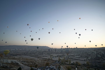 Hot air balloon flying over rock landscape at Cappadocia Turkey
