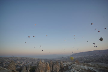 Hot air balloon flying over rock landscape at Cappadocia Turkey