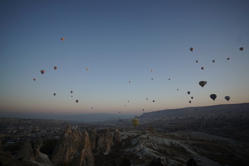 Hot air balloon flying over rock landscape at Cappadocia Turkey