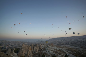 Hot air balloon flying over rock landscape at Cappadocia Turkey