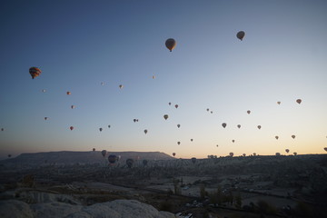 Hot air balloon flying over rock landscape at Cappadocia Turkey