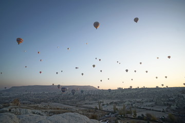 Hot air balloon flying over rock landscape at Cappadocia Turkey