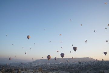 Hot air balloon flying over rock landscape at Cappadocia Turkey
