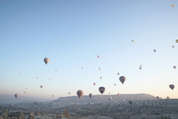Hot air balloon flying over rock landscape at Cappadocia Turkey