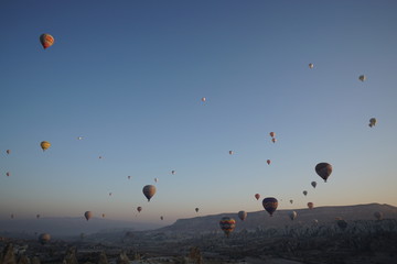 Hot air balloon flying over rock landscape at Cappadocia Turkey