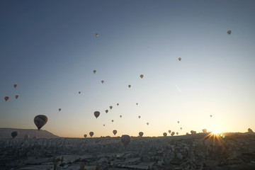 Hot air balloon flying over rock landscape at Cappadocia Turkey