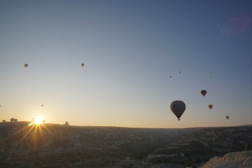 Hot air balloon flying over rock landscape at Cappadocia Turkey