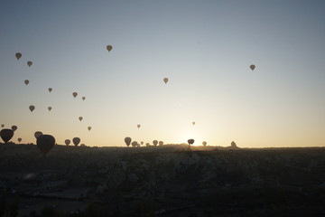 Hot air balloon flying over rock landscape at Cappadocia Turkey
