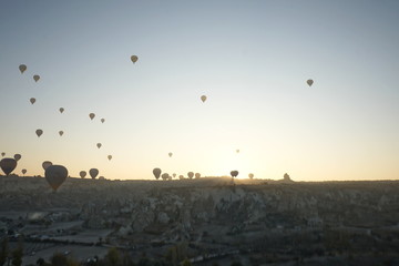 Hot air balloon flying over rock landscape at Cappadocia Turkey