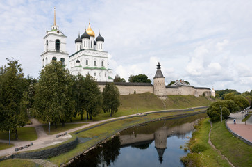 Bazhni of the Pskov Kremlin in Russia are reflected in the water of the moat