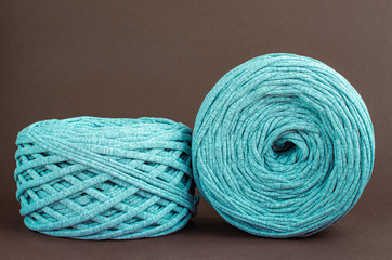 t-shirt yarn balls light blue color on brown background. Handmade craft recycle eco concept