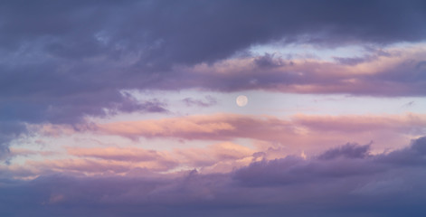 Beautiful full moon on the sunrise sky. Astronomical background.