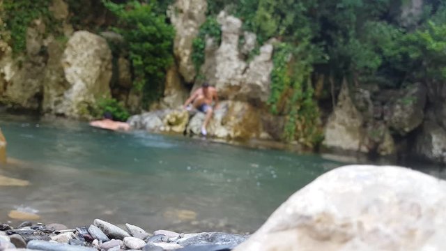 this video show 2 personnes in a blurry background  swimming in a lake, this place is Jijel country of Algeria.