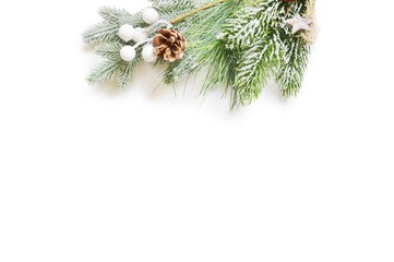 Merry Christmas and Happy New Year background. Flat lay winter holidays mockup. Green fir-tree branch isolated on a white background