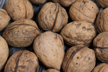 Walnuts. Scattered on painted pine board surfaces.