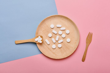Assorted pharmaceutical medicine, Taking too much medication pills on spoon, Overdiagnosis drugs cause bad health.