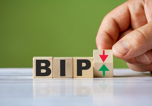 The hand turn wooden block with red and green arrow as change concept of BIP. Word BIP conceptual symbol.