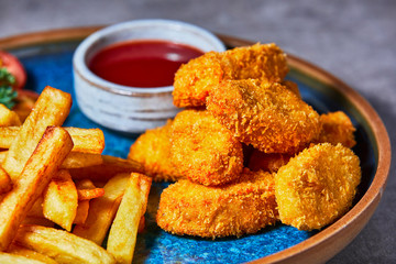 Chiken Nuggets with French Fries and Ketchup.