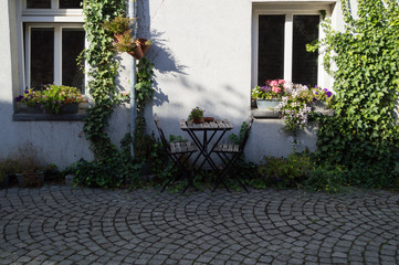 Fototapeta premium Table and Chairs in Front of Dutch House in Maastricht, Netherlands