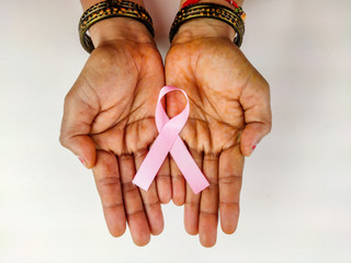 woman Hand holding pink ribbon , Breast cancer awareness symbol, fight against cancer