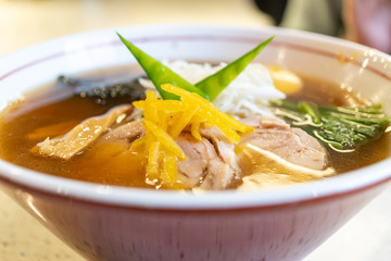 Ramen chicken soup with egg and bamboo shoots in a bowl. Japanese food.