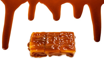 Background of flowing caramel sauce isolated on white.