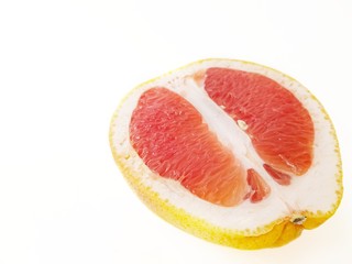 Fototapeta na wymiar Red ripe juicy grapefruit in a cut on a white background. The concept of diet and healthy eating. A place for text. 
