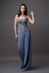 Portrait of a beautiful woman in trendy bodysuit trousers