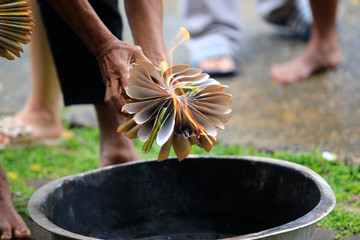 holding the burning funeral paper.