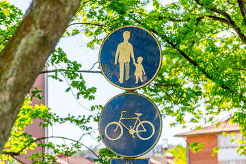Worn walking and biking path sign.
