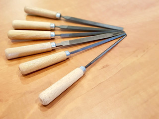 Close up shot of warding file assortment on a wooden table